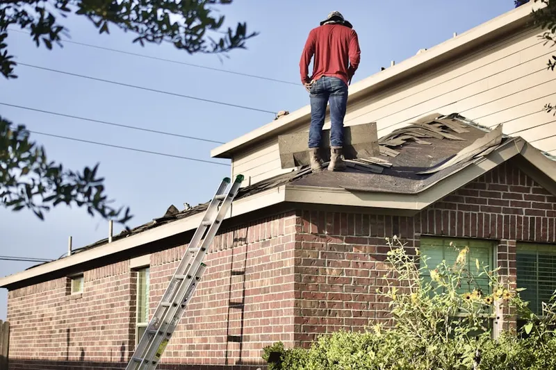 Professional roofer working on a residential roof in Hilliard Run